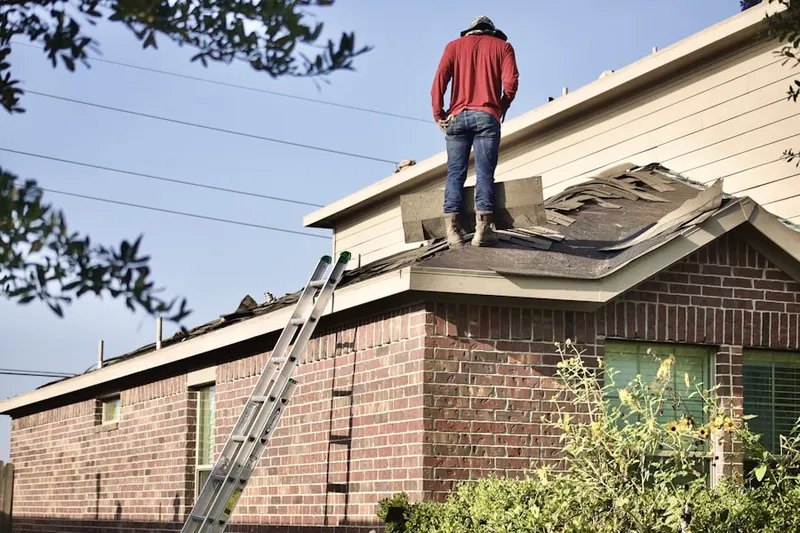 Professional roofer working on a residential roof in Nelighsville